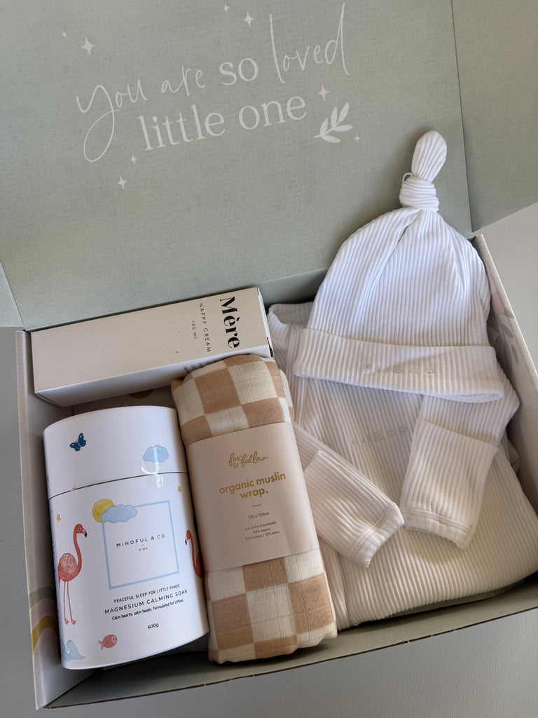 Baby gift set with hat, blanket, and container in a box with 'You are so loved little one' text.