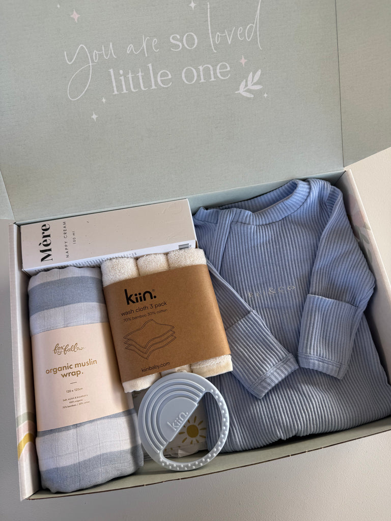 Baby gift set with clothing, wraps, and a container in a box with 'You are so loved little one' text.